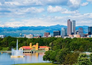 free things to do in Denver, photo of a lake at a park with the Denver skyline and mountains in the background.